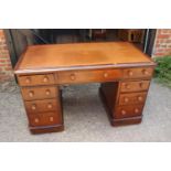 A late 19th century mahogany double pedestal desk with tool lined top, nine drawers with knob