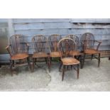 A set of six late 19th century Windsor wheelback chairs with elm panel seats, on turned and