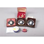An orchid brooch, three Peter Bates miniature cameos, in original boxes, a Royal Doulton 100