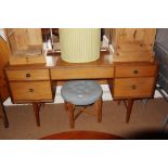 A teak dressing table, fitted triple mirror over five drawers, on shaped supports, 60" wide x 60 1/