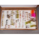 A Richard Wheatley two-division fishing fly box, containing an assortment of flies, 15" wide
