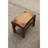 A walnut frame stool with leather top, on turned and stretchered supports, 22" wide x 14" deep x 15"