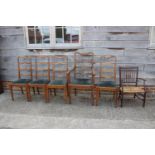 A set of five Arts & Crafts oak ladder back dining chairs with drop-in seats, on square taper