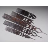 Five Tanzanian carved ebony ceremonial combs (largest 31 1/2" long)