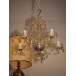 A five-light cut glass chandelier, a pair of gilt wall lights and one other light