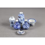 A Chinese blue, white and iron oxide glazed cylindrical miniature vase with warriors in a