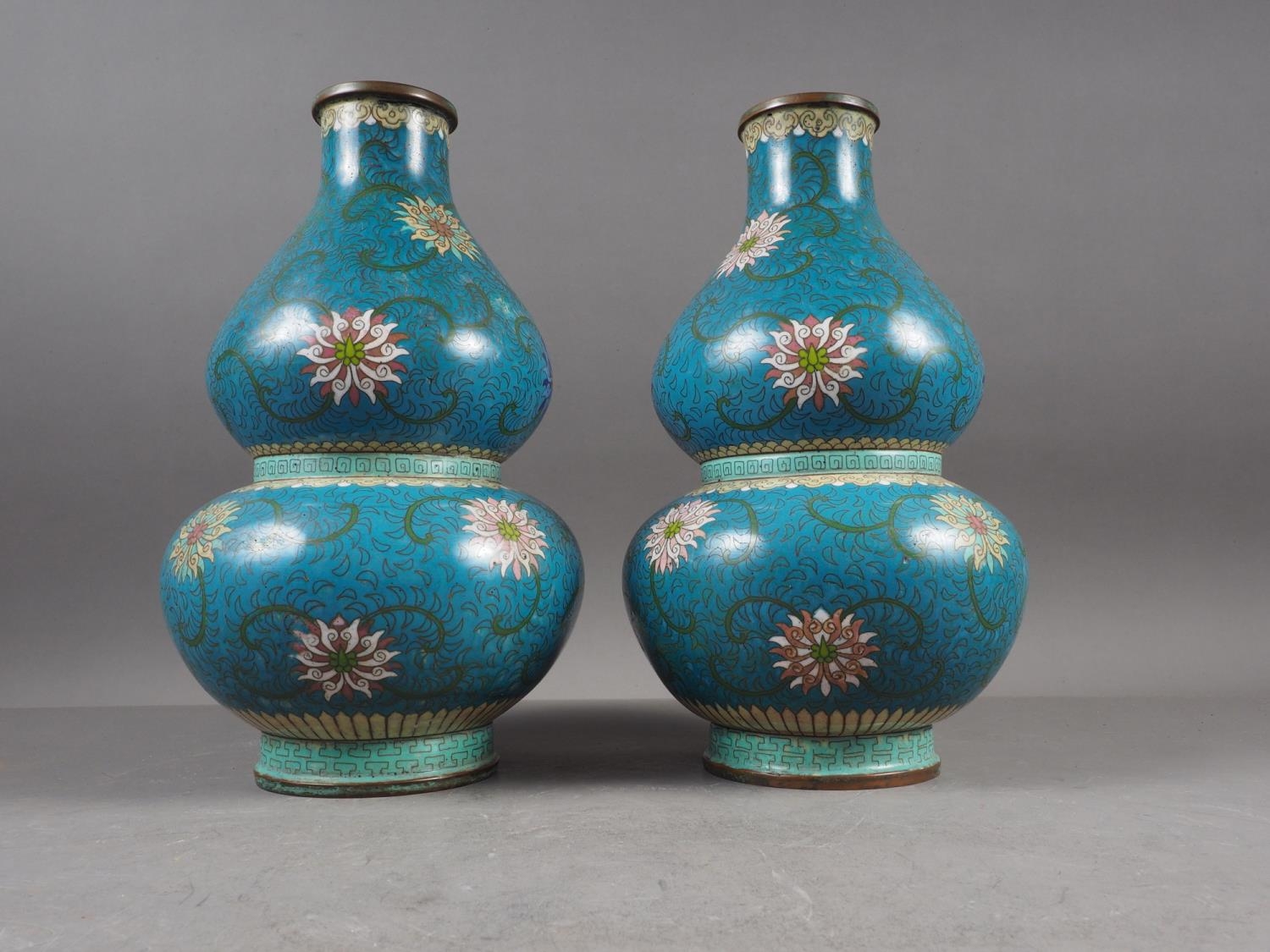 A pair of Chinese cloisonne double gourd vases with floral, scrolled and Greek key designs, 11 1/