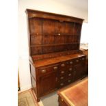 A 19th century oak dresser, the back fitted shelves over five small drawers with three further
