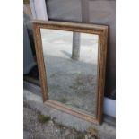 An early 20th century gilt framed wall mirror, plate 21" x 30" approx,ÿa circular bevel edged wall