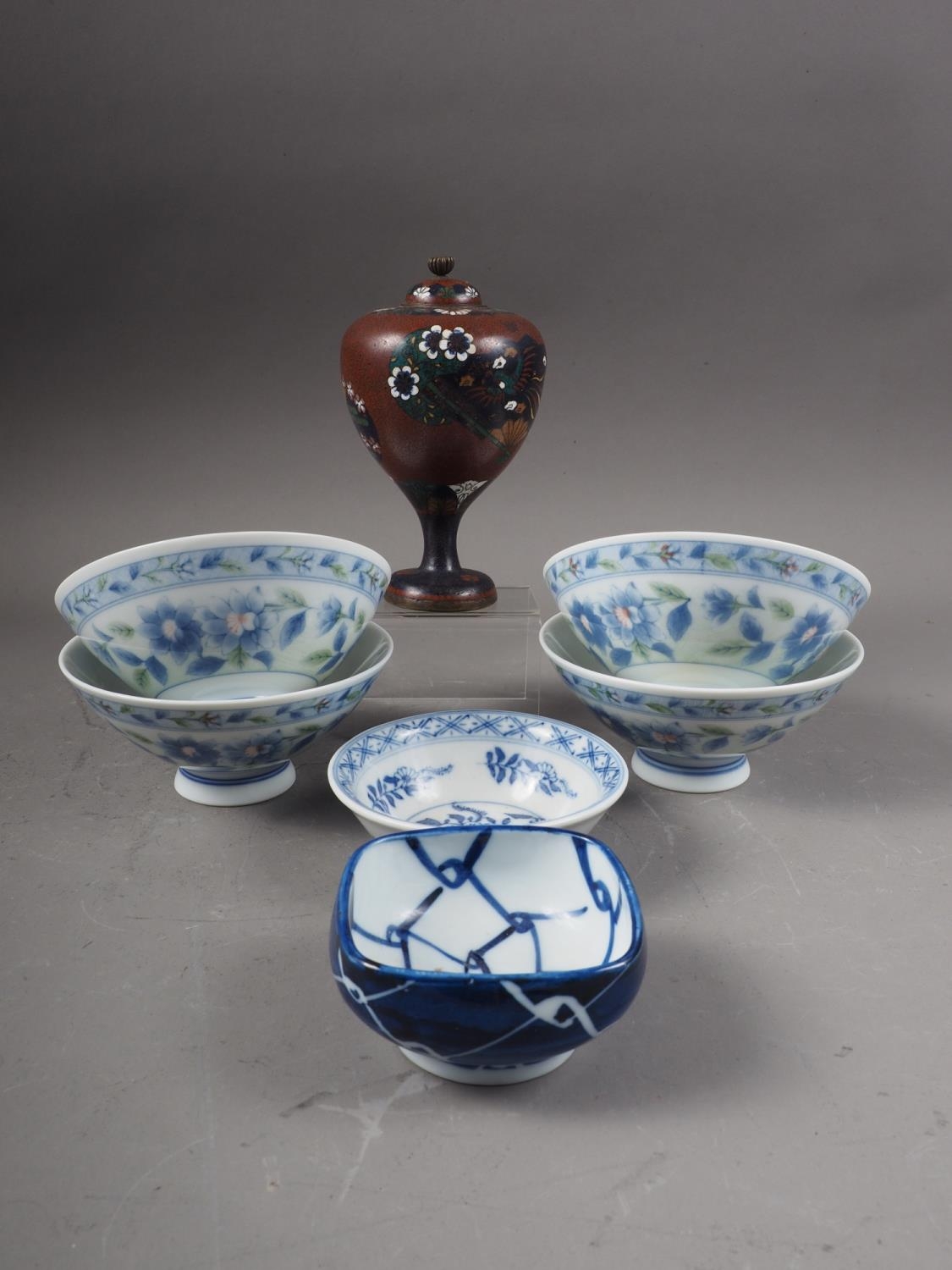 A Japanese cloisonne pedestal jar and cover with panels of bird and flower decoration, 5" high, four