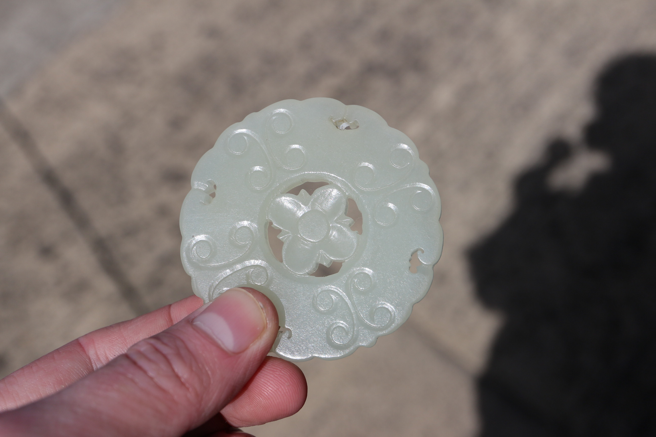 A Chinese carved pale jade pendant, 2 1/4" dia, with stand - Image 12 of 14