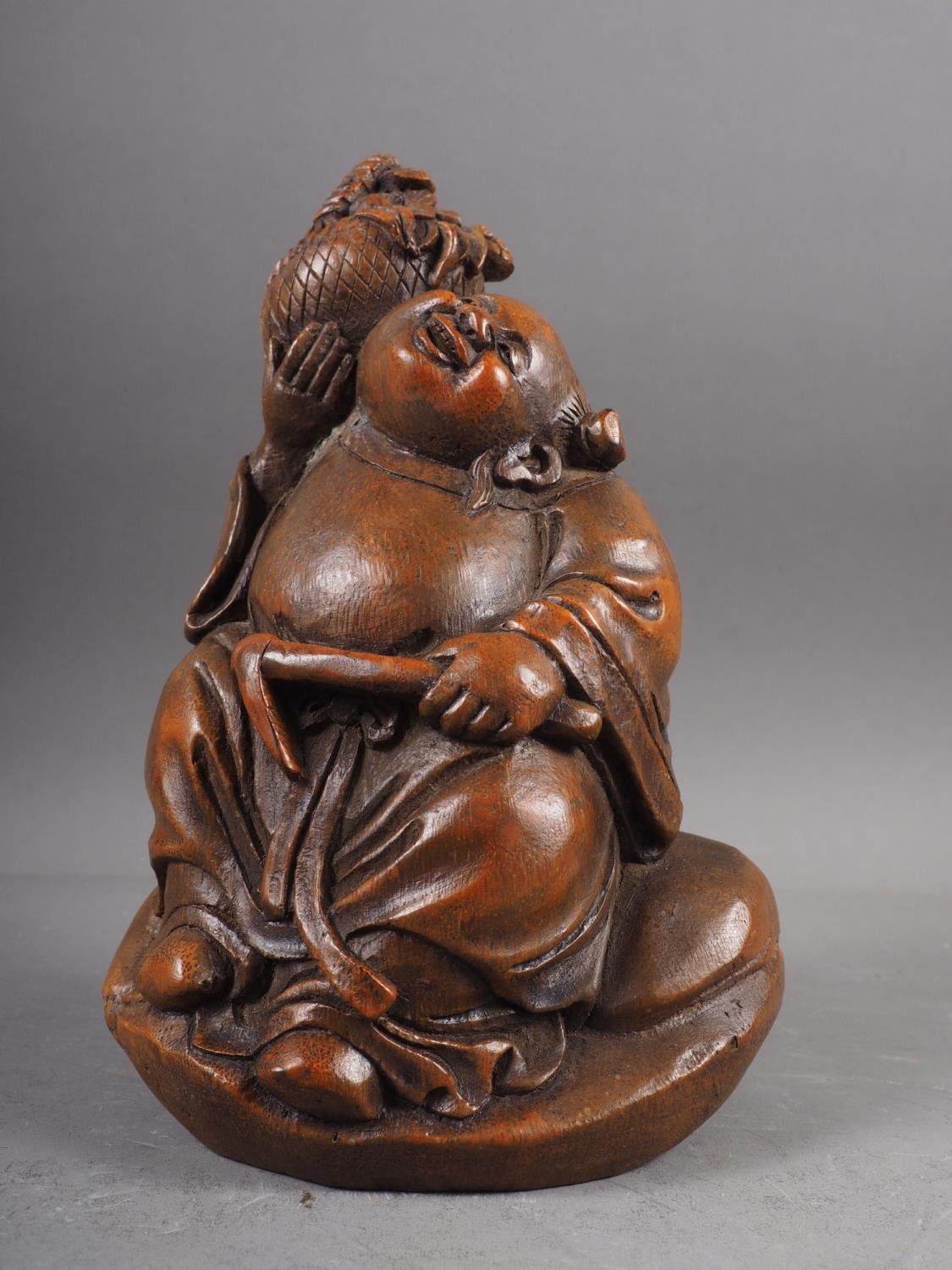 A Japanese carved bamboo figure of a Buddha, 7 1/4" high