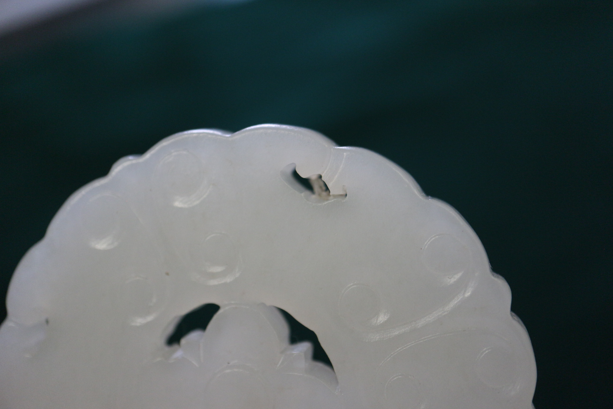 A Chinese carved pale jade pendant, 2 1/4" dia, with stand - Image 6 of 14