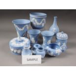 A quantity of Wedgwood light blue jasperware, including a flared rim vase, 6" high, a pair of jars