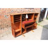 A 1960s teak home office cabinet with fitted interior, pull-out writing surface, adjustable lamp,