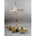 A Manaus brass balance with eight fitted weights, 24 1/2" high