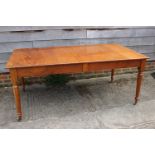 A mahogany extending dining table with three leaves, on reeded supports, 39" wide x 120" long x