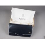 A 1980s Gucci navy blue leather clutch/shoulder bag with detachable strap, in original box and