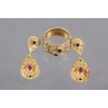 An Indian yellow metal dress ring set diamonds, sapphires and rubies, size O, and a matching pair of