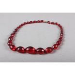 A cherry amber? faceted graduated beaded necklace, 18 3/4" long overall, 48g