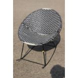 A 1950s metal frame cone-shape rocking chair