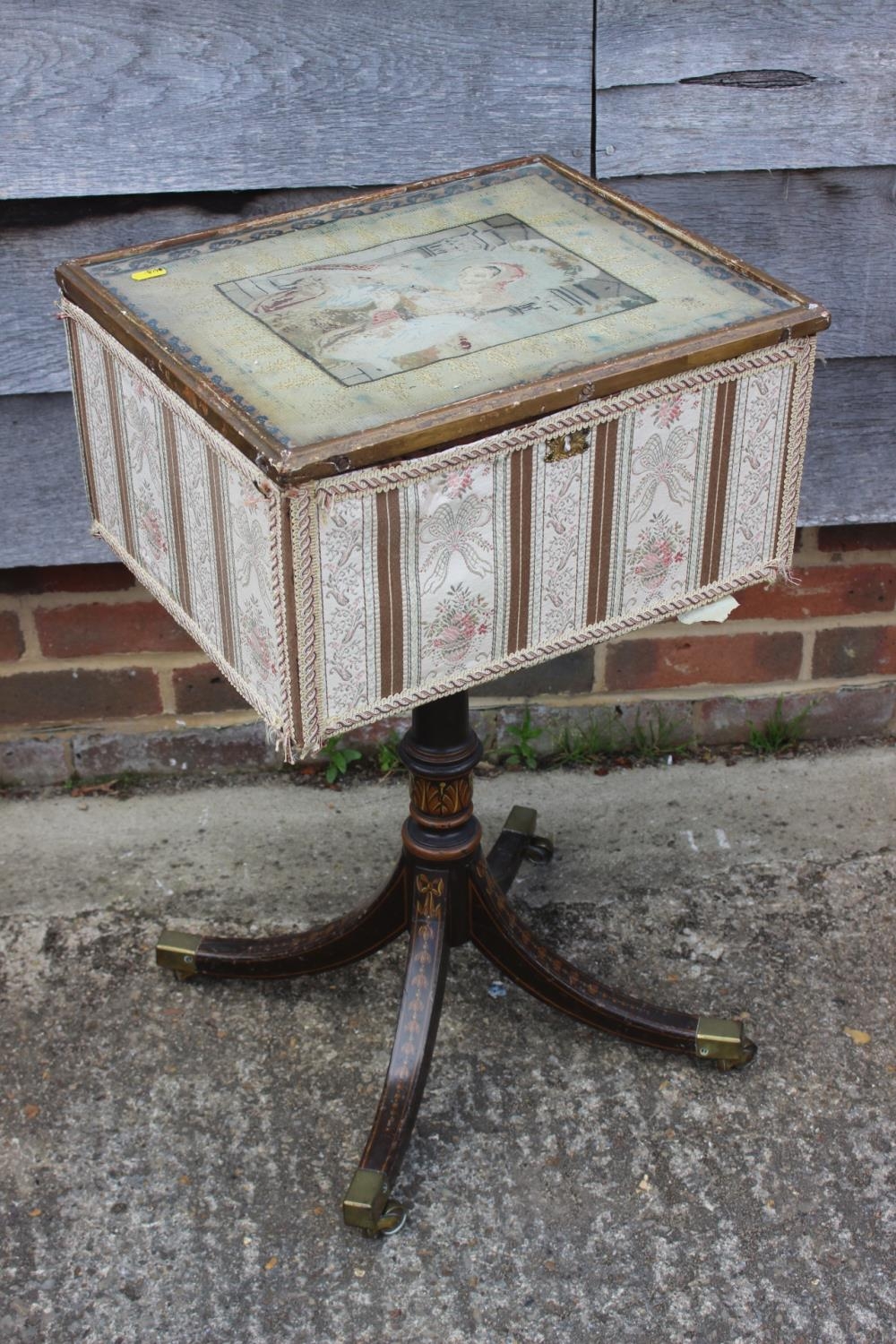 A 19th century work table/box with petit point panel top, on turned painted column and quadruple