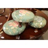 Three modern circular stools, upholstered in a floral fabric, on turned supports, 11 1/2" dia x 6