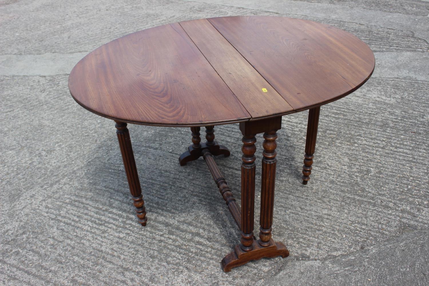 A late 19th century walnut Sutherland tea table, on slender reeded supports