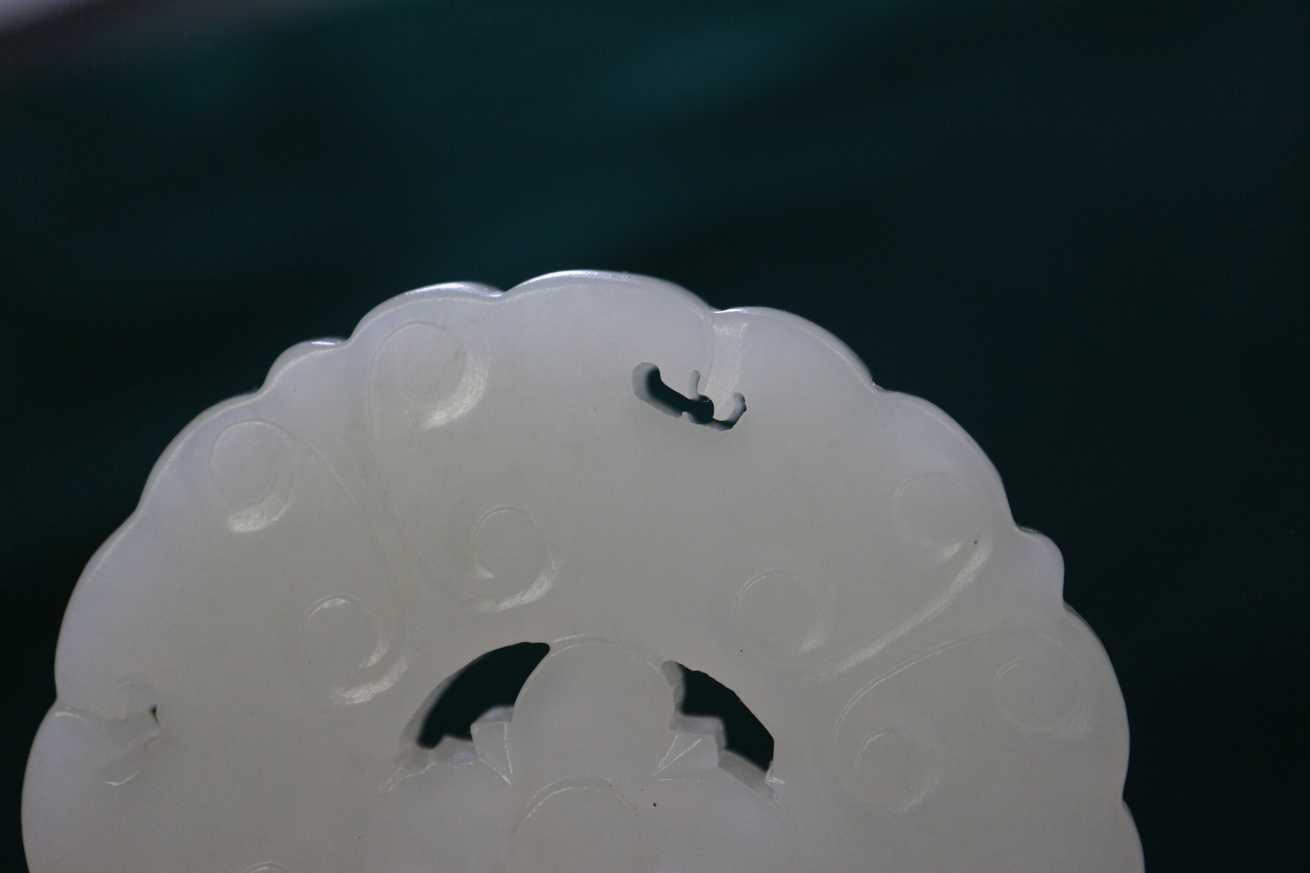 A Chinese carved pale jade pendant, 2 1/4" dia, with stand - Image 10 of 14