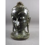 A carved hardstone bust of a deity, on circular base, 12" high