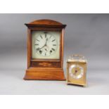 An early 20th century mahogany and inlaid arch topped mantel clock with enamelled dial and Roman