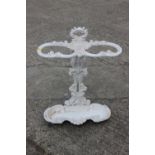 A white painted cast iron scrollwork umbrella stand, 18" wide