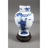 A Chinese blue and white vase with matched lid, with figure and urn decoration, 6 1/4" high, (lid