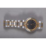 A gentleman's stainless steel and gilt metal bracelet watch with black dial, baton numerals and date