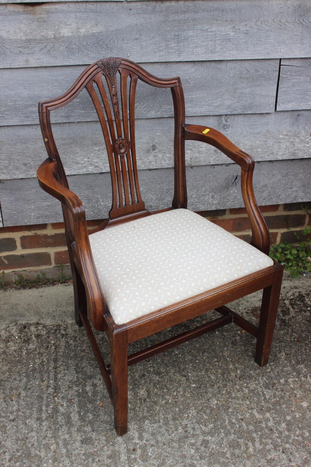 A late Georgian Sheraton design mahogany elbow chair with drop-in seat, on square taper supports