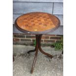 An early 20th century bentwood games table with inlaid top, on tripod splay supports, 21" dia x 28
