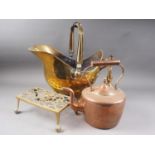 A brass coal helmet, on cabriole supports, a brass trivet stand, a copper kettle and other items