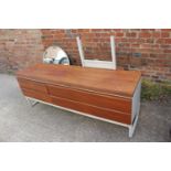 A 1960s teak dressing table, fitted circular mirror over four drawers, 65" wide x 17" deep x 54"
