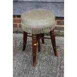 A mid 19th century mahogany piano stool with circular adjustable seat, on reeded stretchered