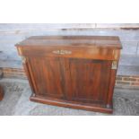 A 19th century rosewood chiffonier, fitted freeze drawer, over cupboards flanked by Egyptian