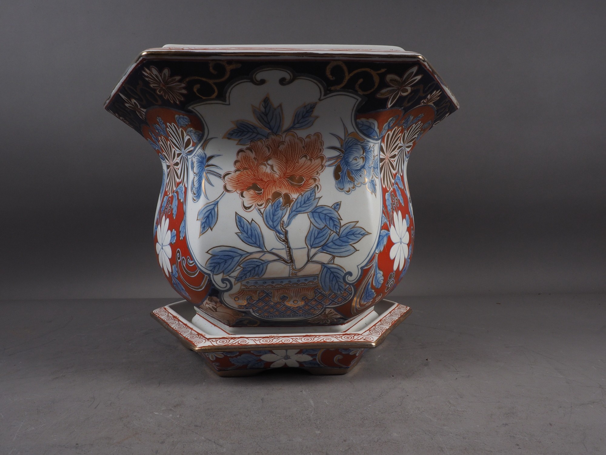 A hexagonal jardiniere with floral decoration in the Imari palette and a matching saucer