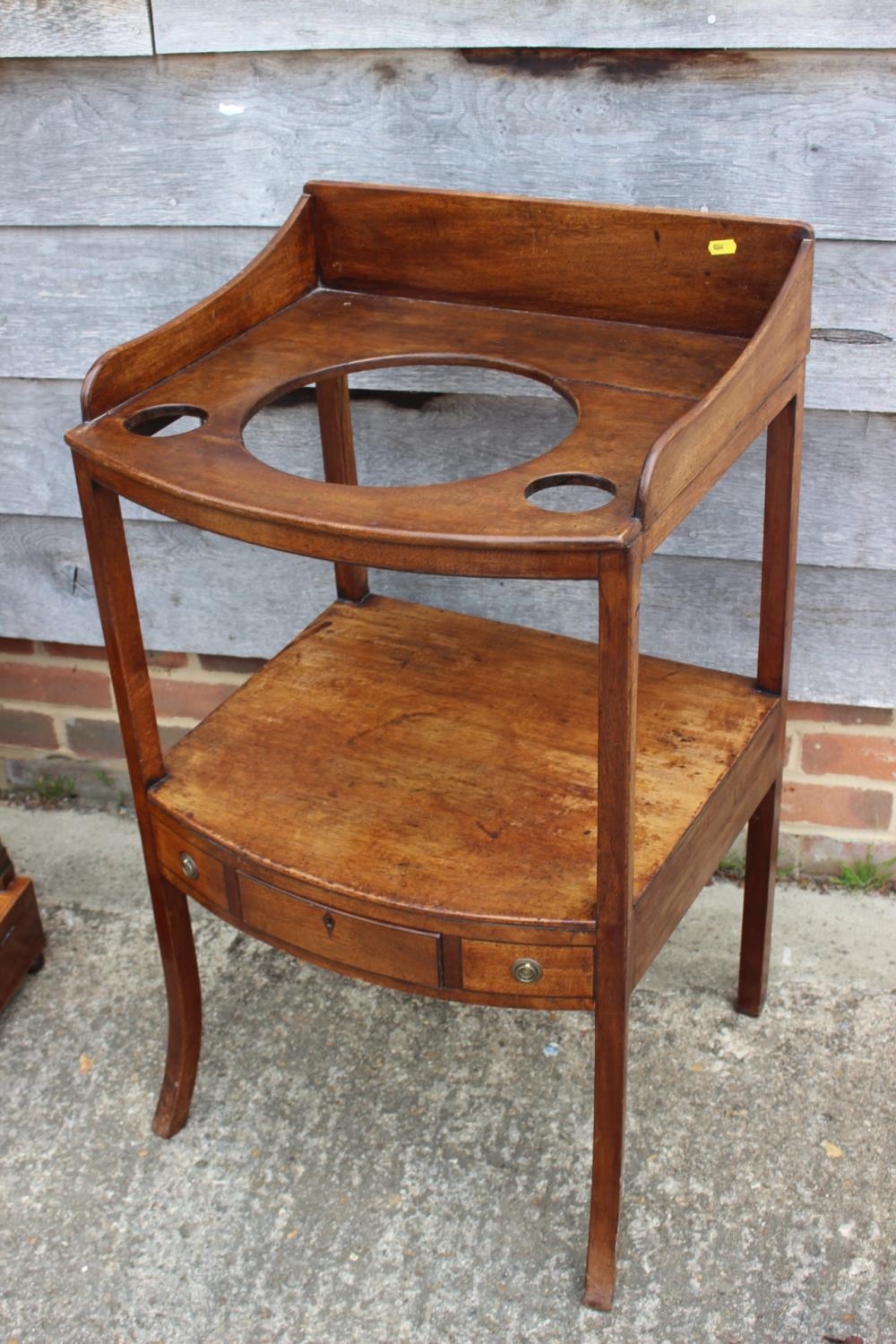 A late Georgian mahogany bowfront washstand, fitted one drawer, on splay supports, 19" wide x 20"