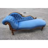 A late 19th century shape-back chaise longue, button upholstered in a blue fabric, on cabriole