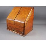 A 19th century burr walnut desk tidy enclosed two doors with calendar cards over writing slope