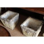 A pair of carved stone garden planters with flower design, 14" square