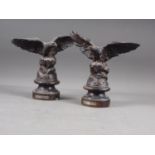 A pair of bronzed model eagles, on circular bases, 10" high