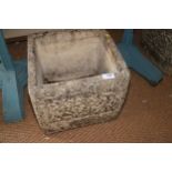 A pair of cast stone scroll decorated planters, 13" square