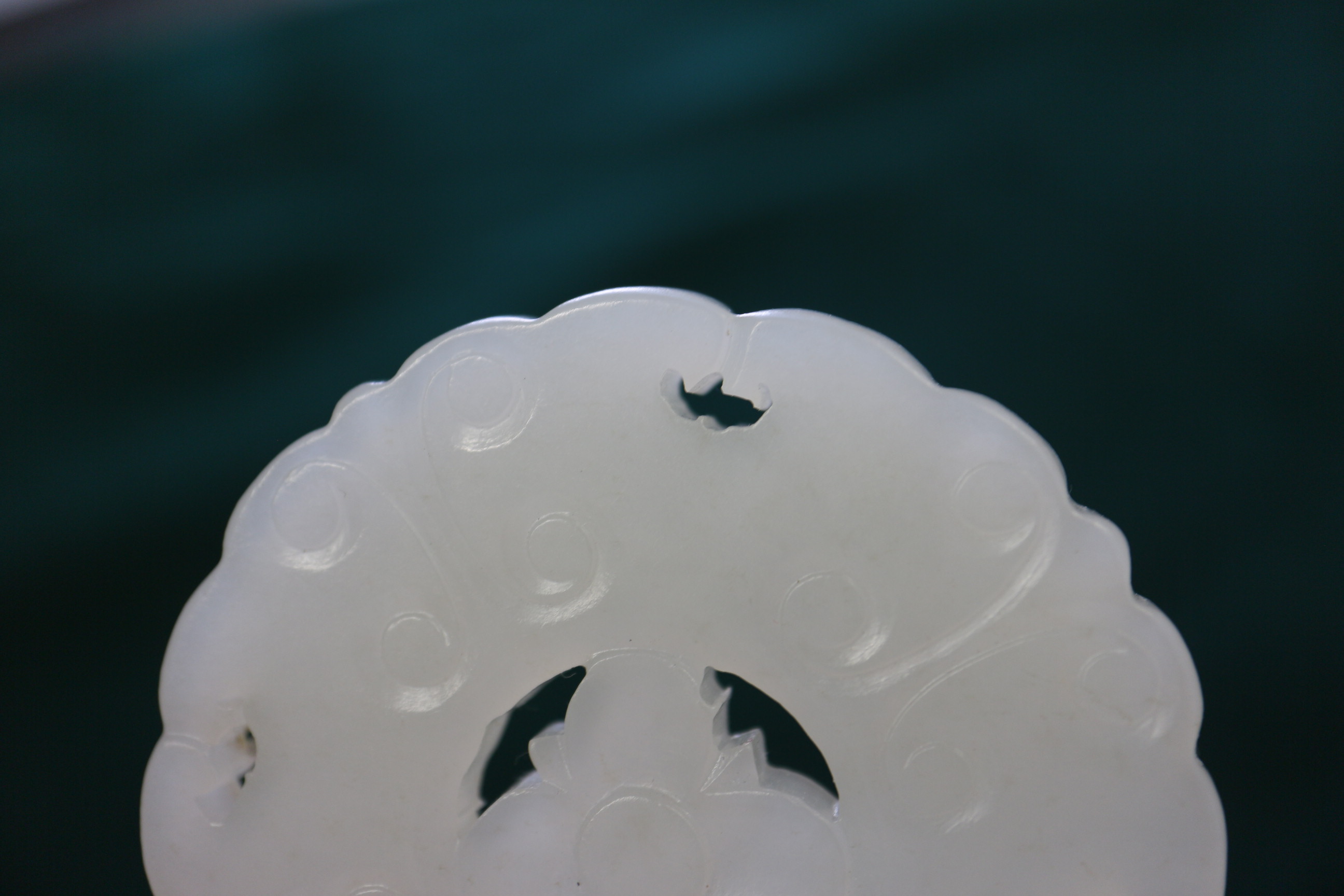 A Chinese carved pale jade pendant, 2 1/4" dia, with stand - Image 8 of 14