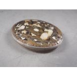 An 18th century white metal, tortoiseshell and mother-of-pearl inlaid oval patch box