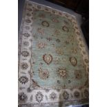 A Persian rug with all-over floral design on a light ground 100" x 60" approx